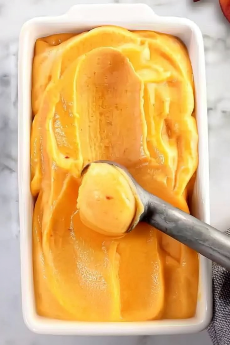 Peach Sorbet – Cool and Fruity Homemade Summer Treat Homemade peach sorbet served in a bowl with fresh peach slices – a refreshing summer dessert